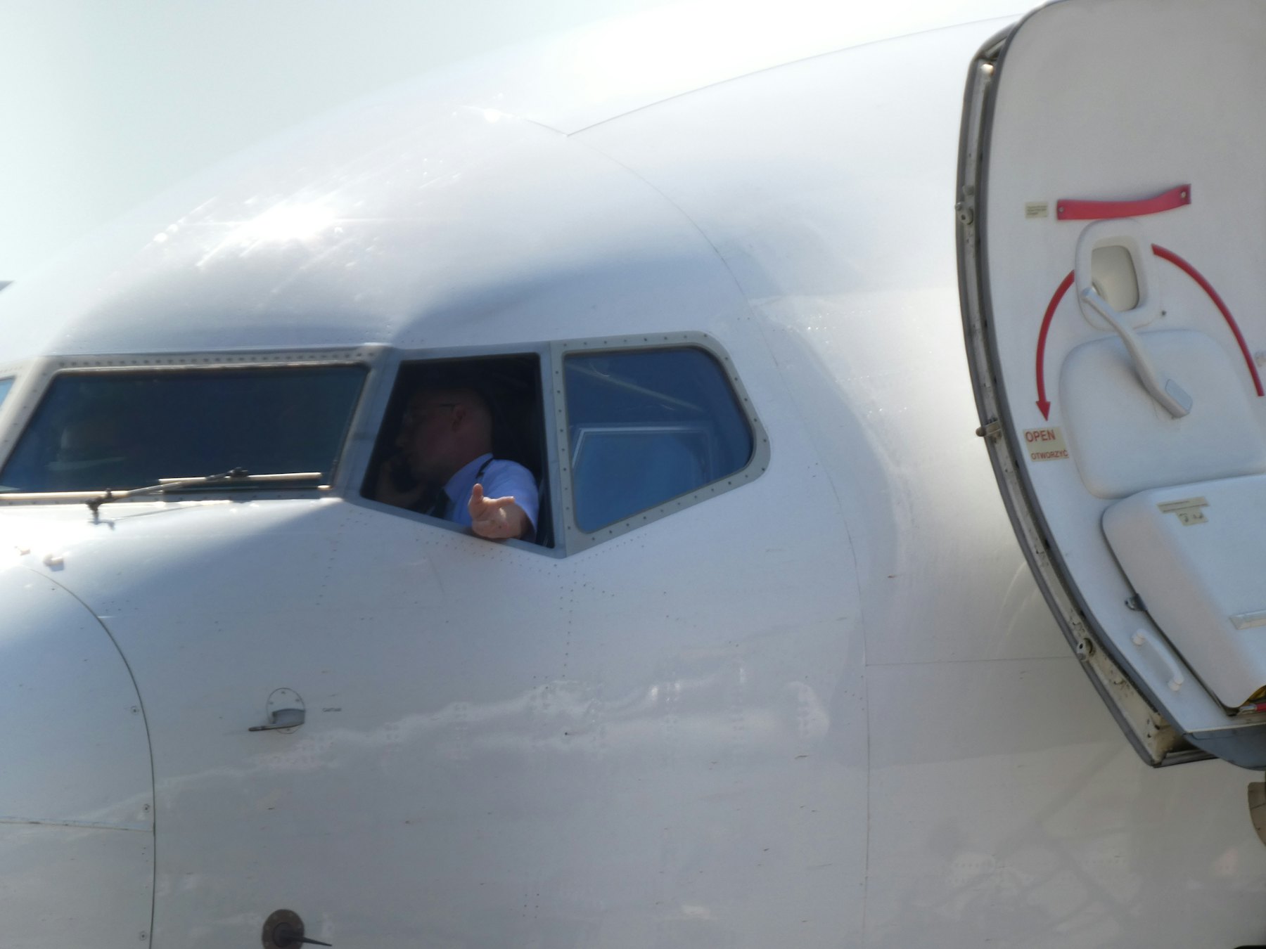 Pilot looking out the cockpit side window before departure