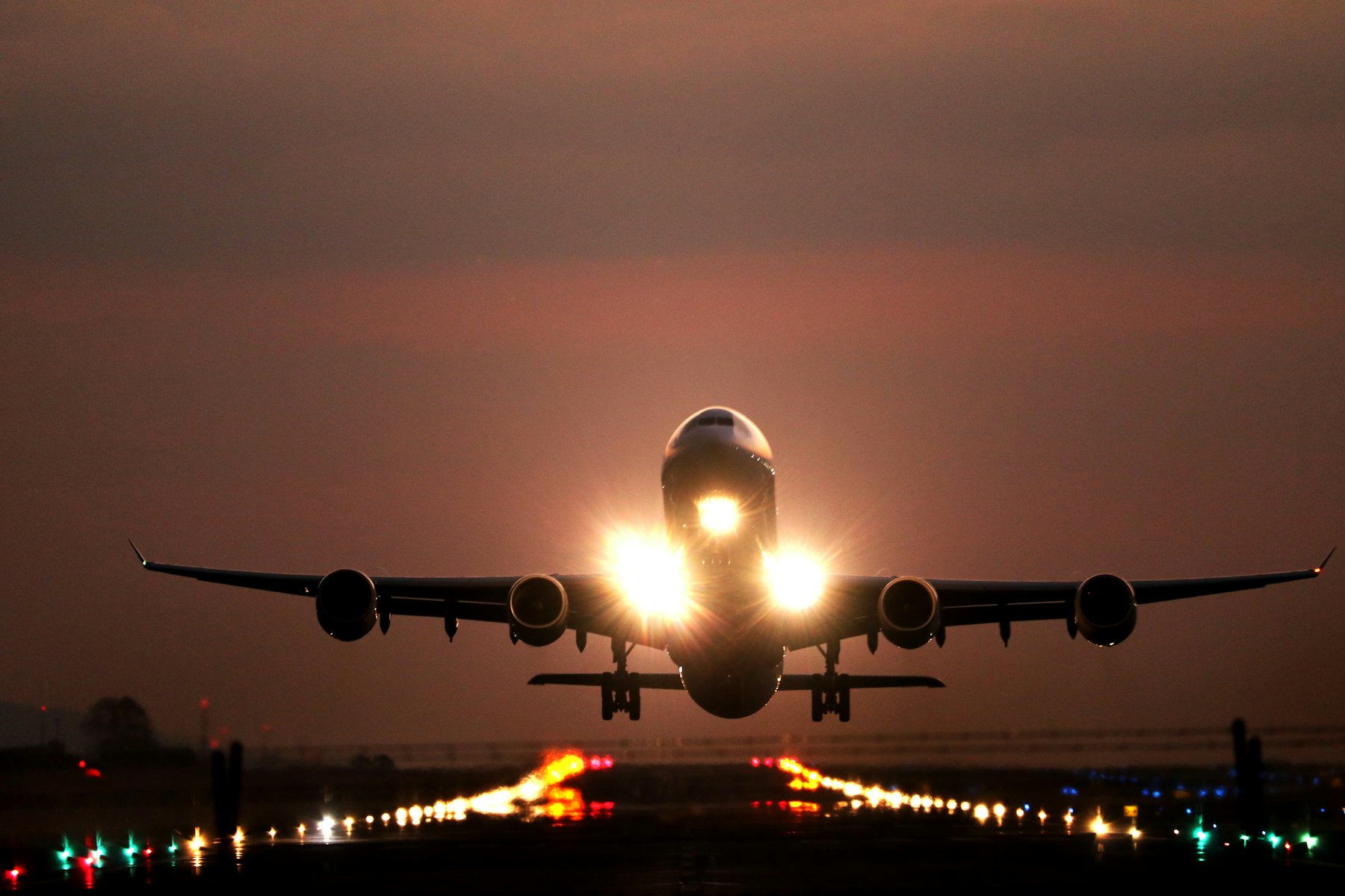 Twin-engine jet on final approach with gear down